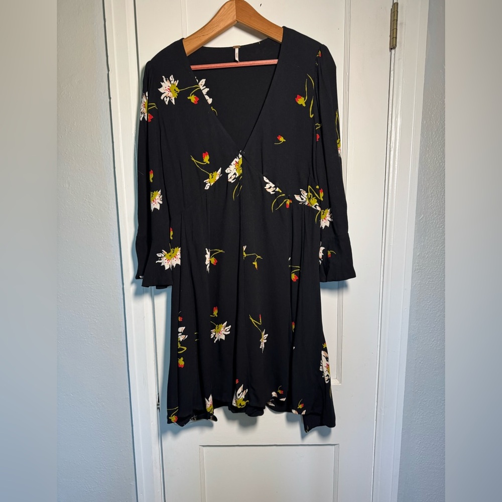 Free People Floral Black Mini Wrap Dress 3/4 length sleeve with ruffle.